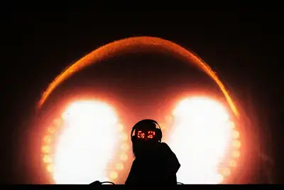 DJ D1 silhouetted on stage
