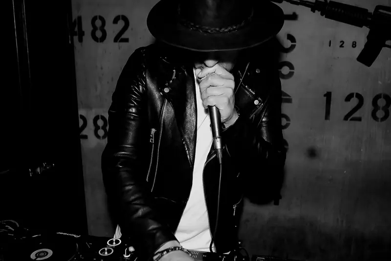 DJ iKhan at the decks, black and white